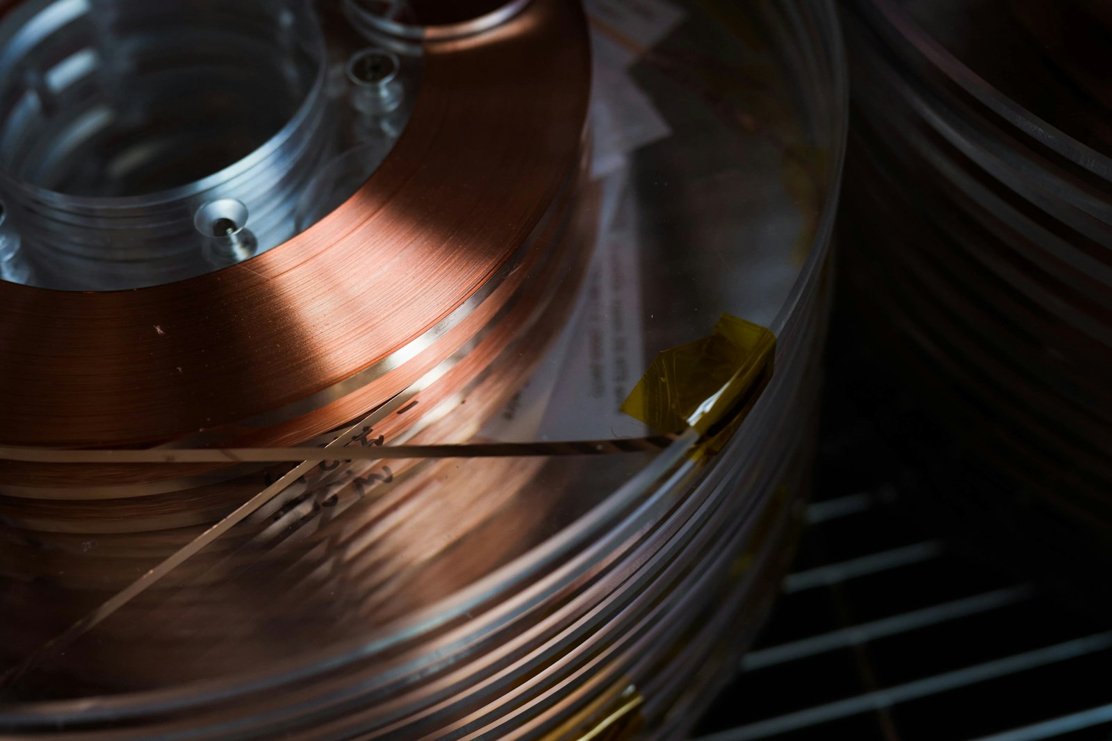 A spool of copper-colored high-temperature superconducting tape